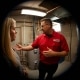 A tech inspecting a water heater with a female customer.